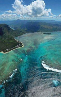 an aerial view of the ocean and land