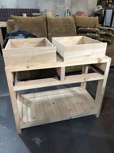 two wooden boxes sitting on top of a table next to couches in a room