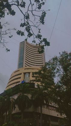 an upward view of the mumbai stock exchange building in mumbai, india on a cloudy day