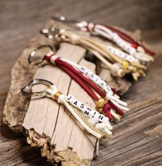 four key chains are sitting on a piece of wood