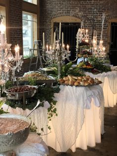 a buffet table is set up with many different foods and desserts on the tables