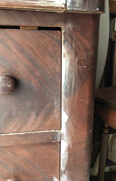 an old wooden dresser with some knobs on it's doors and drawer handles