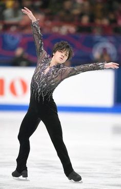 a male figure skating on an ice rink