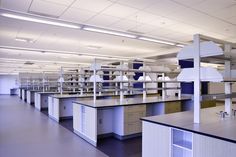 an empty laboratory with lots of cabinets and counters