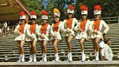 a group of cheerleaders are standing on the bleachers