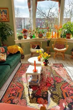 a living room filled with furniture and lots of plants in the window sills