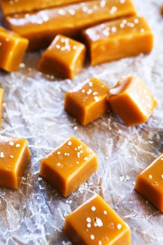 several pieces of caramel candy sitting on wax paper