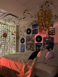 a bed room with a neatly made bed and lots of pictures on the wall