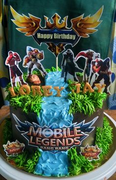 a birthday cake is decorated with an image of mobile legend and the name happy birthday