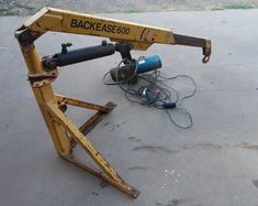 a machine that is sitting on the ground with wires attached to it's back