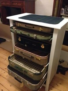 four suitcases stacked on top of each other in a room with wood flooring