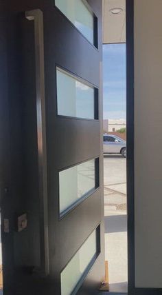 an open door leading to a parking lot