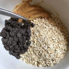 a bowl filled with oatmeal, chocolate chips and peanut butter