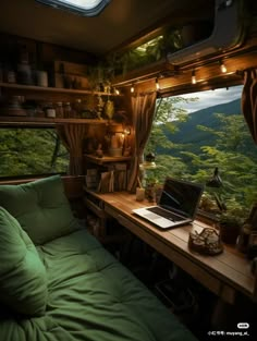 a laptop computer sitting on top of a bed in a room filled with green furniture