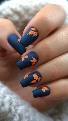 Matte blue nails with orange leaf designs create a striking and unique fall manicure. This bold color combo perfectly captures the essence of autumn. Click the pin and follow us for more stylish nail ideas! #MatteNails #BlueNails #OrangeLeafDesigns #FallManicure #NailInspo Teal And Mustard Nails, Fall Mat Nails Ideas, Blue Pumpkin Nail Art, Matte Orange Nails Short, Leaf Pattern Nails, Autumn Leaf Nails Design, Fall Nail Designs Navy Blue, Cute Autumn Nail Designs, Fall Ideas Nails