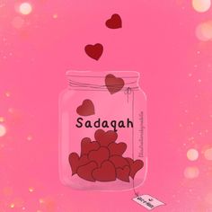 a jar filled with hearts sitting on top of a pink surface