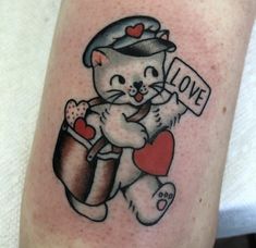 a small tattoo of a cat holding a heart with the word love written on it