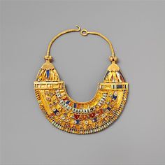 an ancient gold necklace with multicolored stones