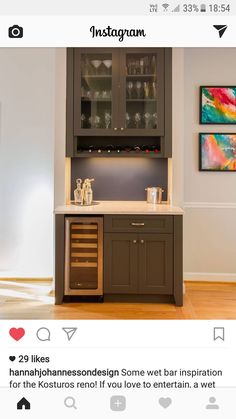 a kitchen with wooden floors and cabinets in the corner, including a wine glass cabinet