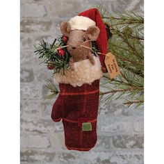 a christmas ornament hanging from a tree with a mouse in a stocking