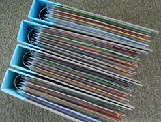 a stack of folders sitting on top of a carpeted floor next to each other