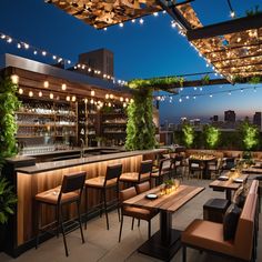 an outdoor bar with lots of seating and lights hanging from the ceiling above it at night