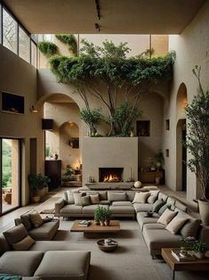 a living room filled with lots of furniture next to a fire place in a building