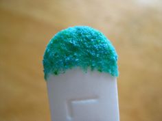 a toothbrush with green sprinkles on it's top and bottom