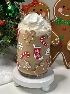 there is a cup with whipped cream and gingerbreads on it