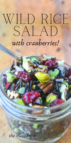 wild rice salad with cranberries and walnuts in a glass bowl on a wooden table