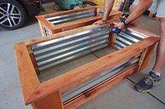 a man is working on some metal and wood furniture