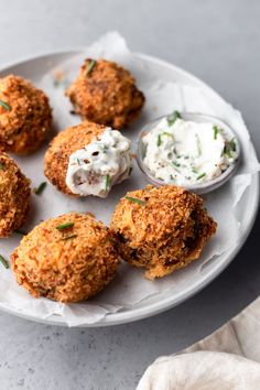 a white plate topped with crab cakes and cream