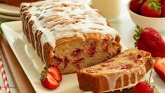 a loaf of strawberry bread on a plate with strawberries