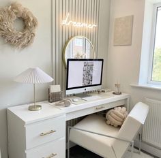 a white desk with a computer on it and a chair in front of the desk