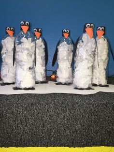 penguins made out of plastic bottles sitting on top of a table