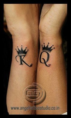 two people with matching tattoos on their arms, both wearing crowns and the letter q