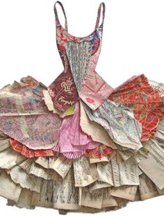 a woman's dress made out of old books and paper machs is displayed on a white background