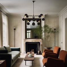 a living room with couches, chairs and a fireplace in it's center