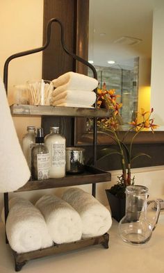 towels are stacked on a shelf in the bathroom