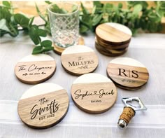 wooden coasters with names on them sitting on a table next to a glass and bottle opener