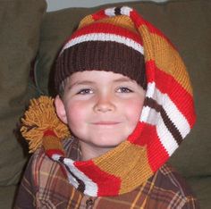 a young boy wearing a knitted hat and scarf