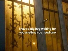 a window with butterflies on it and the words i have a big hug waiting for you anytime you need one