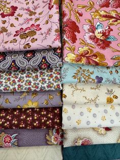 many different types of fabric are stacked together