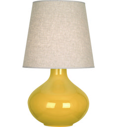 a yellow table lamp with a beige shade