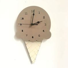 an ice cream cone clock on a white wall