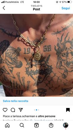 a man with tattoos on his chest wearing a gold chain and a coin pendant necklace