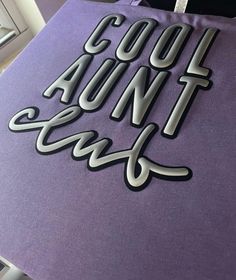 a purple bag with the words cool and funny on it sitting on top of a table