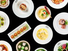 an overhead view of several plates with different food items on them, including meats and veggies