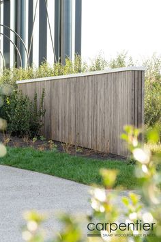 a wooden fence sitting next to a lush green field