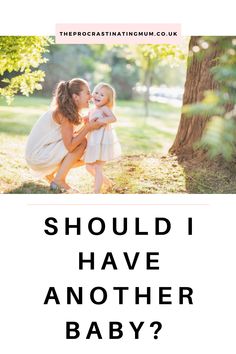 a mother holding her baby in front of a tree with the words should i have another baby?